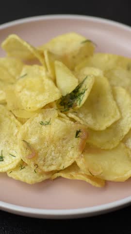 Crisps fried with salt, spices and garlic. Cooked potatoes as a background for your design