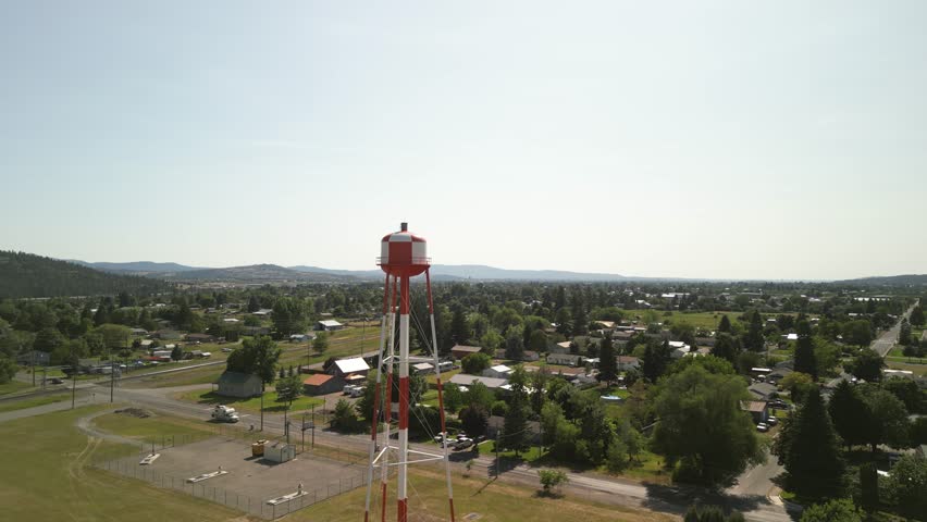 Aerial of red and white water tower in Spokane Valley Washington in spring