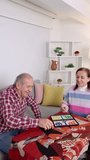 Retired seniors engaging in board game, sharing joyful moments of connection and laughter within cozy living room setting, displaying warm companionship during leisure time - Powered by Shutterstock - Get 15% off with code: PIKWIZARD15