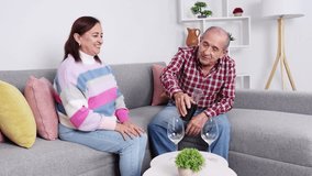 Senior couple sharing intimate wine moment, relaxing together in cozy living room, embodying retirement joy and companionship - Powered by Shutterstock - Get 15% off with code: PIKWIZARD15