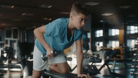 Teenage boy with slender weak body training with inspiration at gym - Powered by Shutterstock - Get 15% off with code: PIKWIZARD15