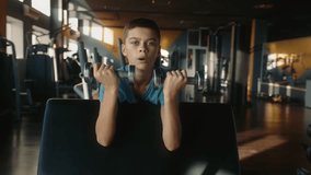 Teen boy with slender weak body training with inspiration at gym - Powered by Shutterstock - Get 15% off with code: PIKWIZARD15