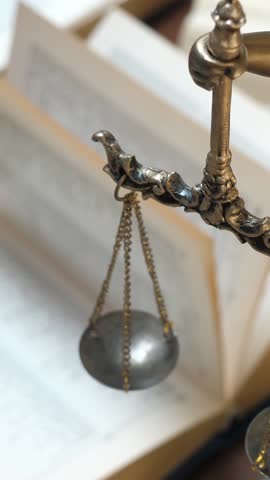 Unrecognizable lawyer's hand works with papers and law books in courtroom or office. Concept of justice and law, attorney or court judge