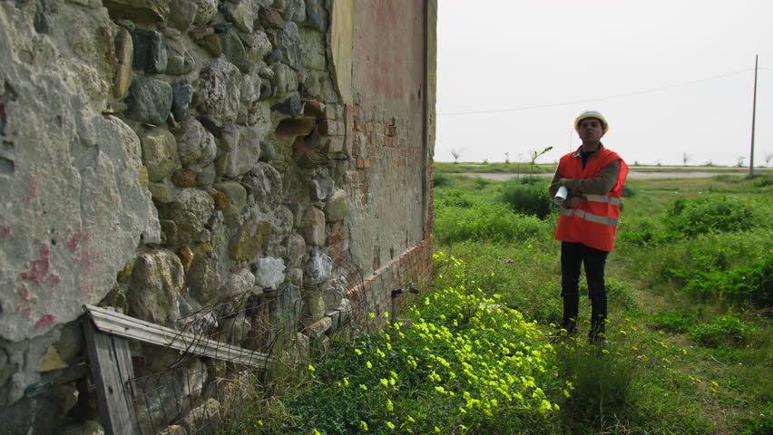 Architect Looking At The Project And The Building To Rebuild