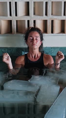 Healthy Woman Diving into Cold Water of Swimming Pool with Ice Cubes for Body Health. Pretty Person in Bath Reservoir Full of Frosty Aqua for Youth Therapy. Cure of Depression and Anxiety Condition