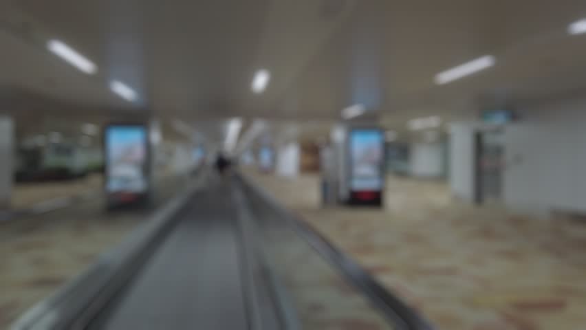 Bokeh view of arrival zone of Indira Gandhi International Airport in New Delhi, India. Blurred background footage.