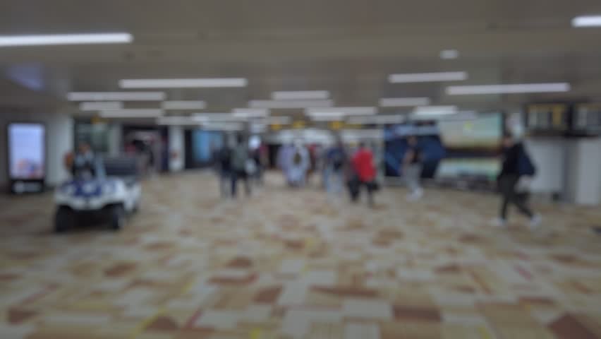 Bokeh view of arrival zone of Indira Gandhi International Airport in New Delhi, India. Blurred background footage.