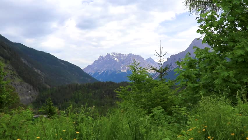 Panoramic view of Germanys largest mountain Zugspitze alpine landscape with turquoise Blindsee lake forest rocks hills and mountains in the Alps Biberwier Reutte Tyrol Austria.