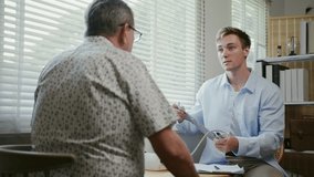 Doctor providing medical consultation to senior man at home, representing aging society healthcare and personalized house call services. - Powered by Shutterstock - Get 15% off with code: PIKWIZARD15