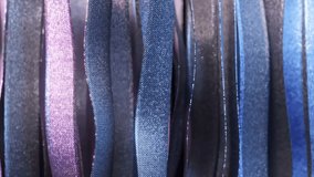 Metallic ribbons with iridescent shimmer gently undulating, weaving luminous blue and purple hues into a hypnotic visual choreography of fluid motion and elegant design. 3D Illustration - Powered by Shutterstock - Get 15% off with code: PIKWIZARD15