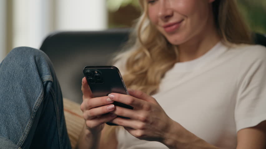 Caucasian happy woman user holding mobile phone using smartphone browsing app internet businesswoman chatting cellphone typing message texting online business female delivery shopping sitting at home