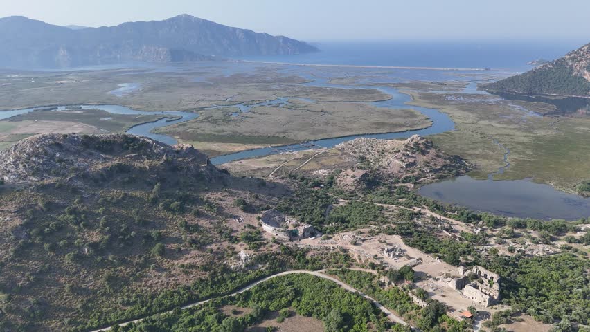 View from acropolis on top of mount to famous ancient Greek city Kaunos in Caria or Caunus in Roman period in Anatolia. Popular place for family travel on summer vacation. Dalyan, Mugla, Turkey