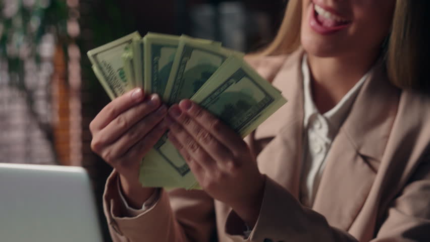 Close up happy glad rich wealthy Caucasian business woman female businesswoman boss laptop employer entrepreneur girl holding hands fan stack money cash salary wage income profit dollars indoor office