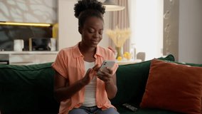 Upset shocked frustrated African American ethnic business woman female girl lady businesswoman user client hold mobile phone smartphone shaking head no bad betting losing money gambling error at home - Powered by Shutterstock - Get 15% off with code: PIKWIZARD15