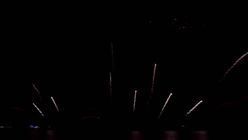 Amazing beautiful colorful firework display over sea on celebration night. Fireworks show for happy new year,