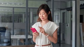 Smiling mature female businesswoman holding smartphone in office for transaction, trading, work chatting online. Young Asian business woman manager ceo using cell phone mobile application. Close up - Powered by Shutterstock - Get 15% off with code: PIKWIZARD15