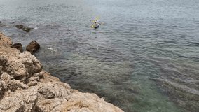 The young couple are happily navigating together in a light blue kayak with yellow paddles - Powered by Shutterstock - Get 15% off with code: PIKWIZARD15