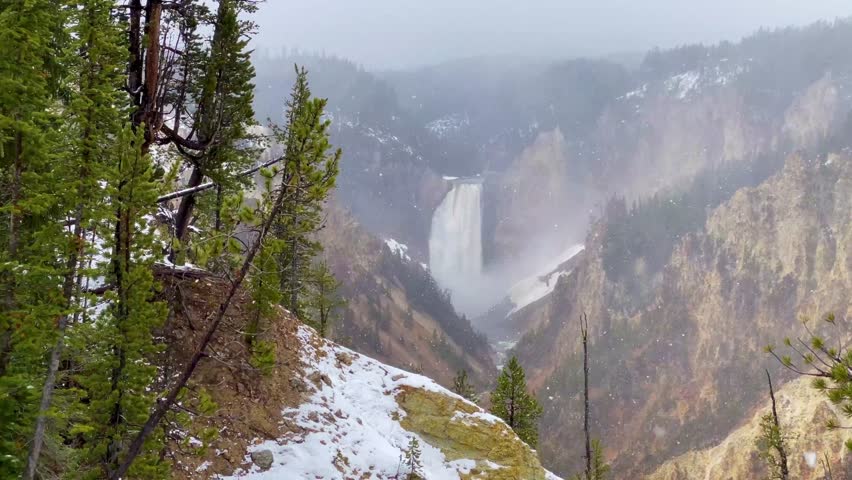 Lower falls of the Yellowstone National Park at the end of May while snowing 
