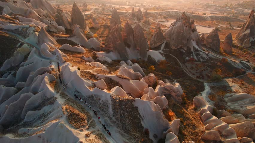 Travel tour excursion on horse in Cappadocia, sunset time in Goreme Turkey Aerial top view.
