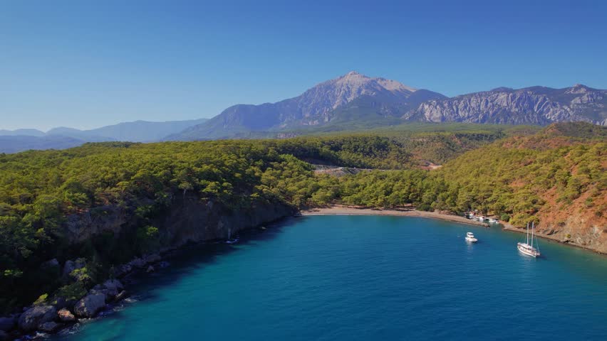 Tropical beach white yacht on blue sea Antalya, Turkey Aerial top view. Concept beautiful travel summer landscape.