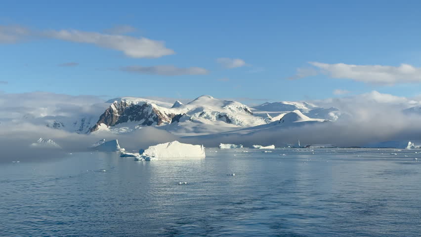 Big Iceberg in Antarctica Winter Scenery, Amazing Shape Ice Formation of Massive Large Enormous Blue Icebergs in Antarctic Peninsula Landscape Seascape with Ocean Sea Water