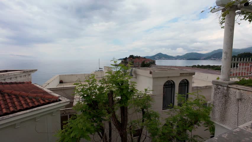 Sveti Stefan Stari Grad old town city in Montenegro Europe on an overcast Spring day mountainous coastline 