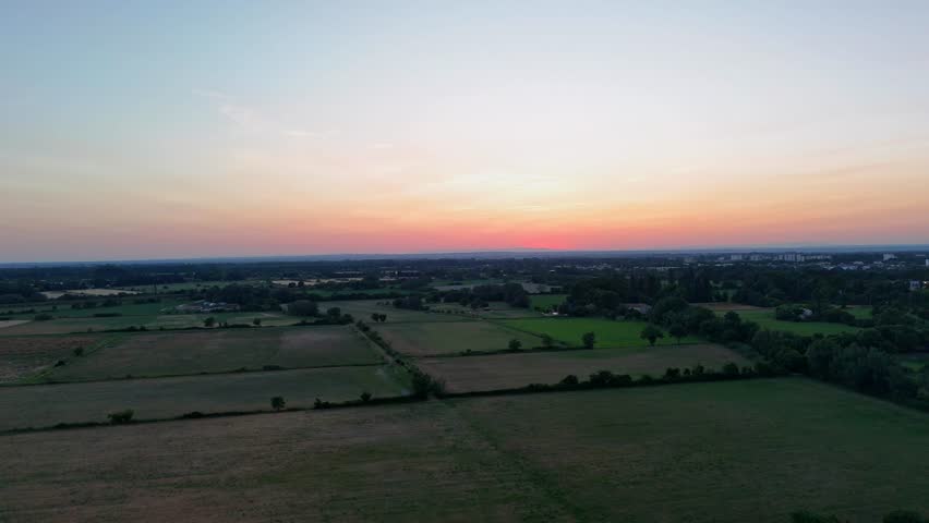 Aerial View of Rural Fields at Sunset Over Horizon