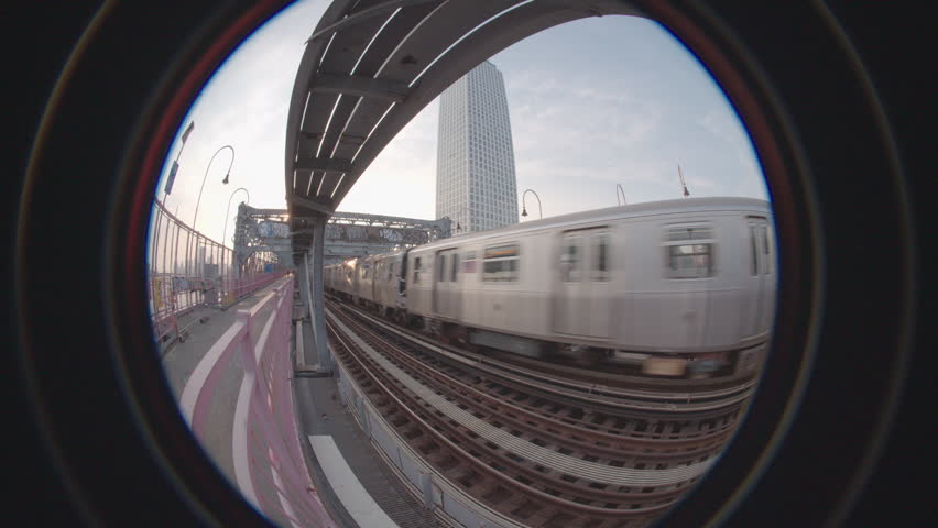 Handheld shot of the subway crossing Brooklyn's Williamsburg Bridge. Shot with a fish-eye lens in New York City.