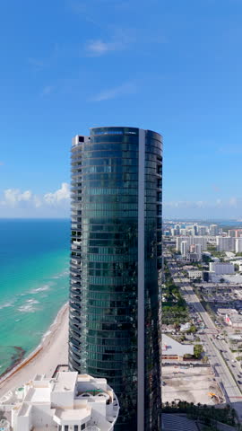 High vertical aerial video above skyscrapers on the beach. Aerial view Sunny Isles Beach Florida USA