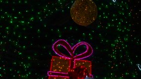 Christmas tree lights twinkling with snowflakes and gift boxes. Glowing green lights softly illuminating decorative snowflakes and wrapped gift boxes adorning festive christmas tree branches - Powered by Shutterstock - Get 15% off with code: PIKWIZARD15