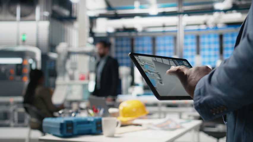 Industrial specialist checking digital manufacturing systems on tablet, solar energy production line in the factory. Black expert showcases industry engineering in solar plant. Close up. Camera B.