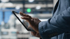 Industrial specialist checking digital manufacturing systems on tablet, solar energy production line in the factory. Black expert showcases industry engineering in solar plant. Close up. Camera A. - Powered by Shutterstock - Get 15% off with code: PIKWIZARD15