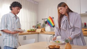 Asian transgender woman and her male partner eating breakfast in house. Attractive loving LGBTQ couple spending free leisure time together, dating and enjoying daily life in cozy kitchen at home. - Powered by Shutterstock - Get 15% off with code: PIKWIZARD15