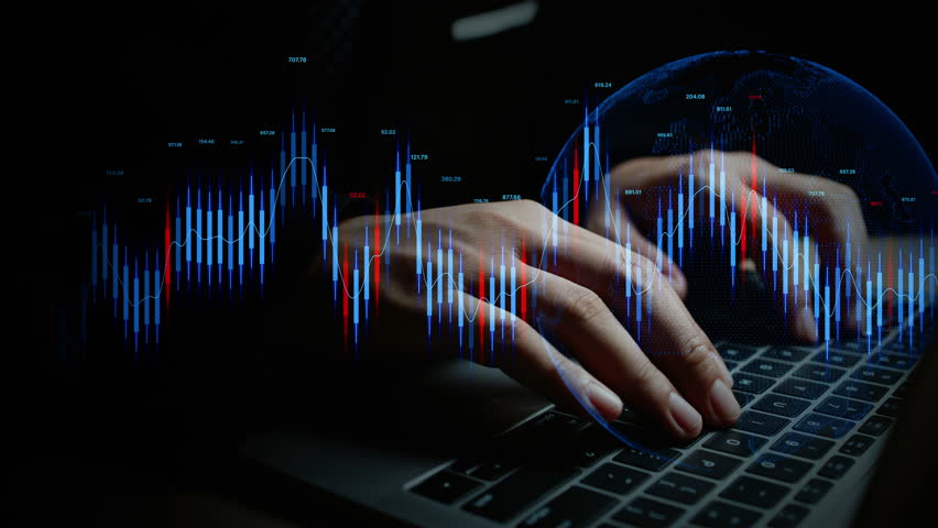 Close-up of hands on laptop keyboard with glowing financial charts and data, representing stock trading, investment analysis, and real-time market trends.
