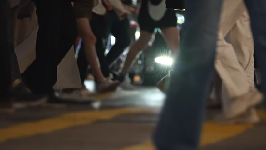 Crowd Walking On Pedestrian Crossing In Hong Kong. Crowded Pedestrian Crosswalk Bustling With Anonymous People Walking Across Urban Street During Rush Hour In Downtown Hong Kong, Capturing City