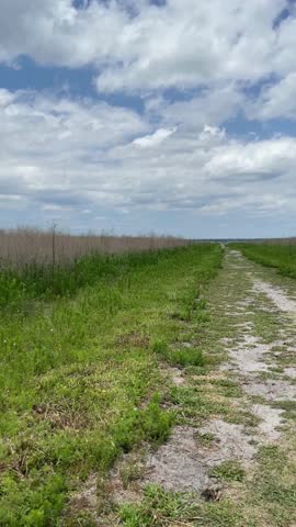A beautiful scenic of the straight dirt sandy road panoramic of the valley flat place nature