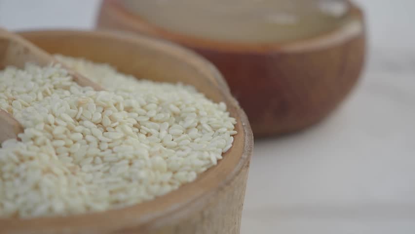 Healthy cooking with sesame seeds in wooden bowls