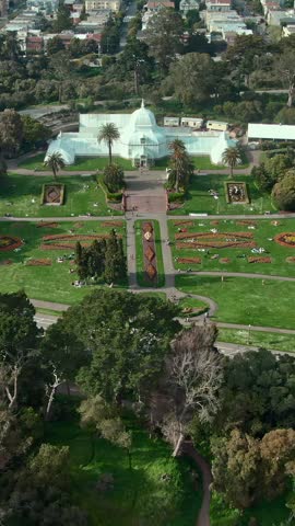 Aerial view of Golden Gate Park in San Francisco, USA. People relax on the grass near the Conservatory of Flowers, enjoying the scenery and sunshine.