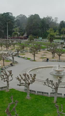 Golden Gate Park in San Francisco, USA. People relax on benches near a fountain, enjoying the park