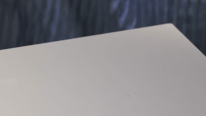 a full white bowl with fresh fruit piece salad is placed by a human hand on the table for a healthy meal, zoom