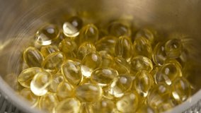 Yellow Vitamin D3 softgels in metallic container. Nutrient supplement capsules. Macro shot - Powered by Shutterstock - Get 15% off with code: PIKWIZARD15