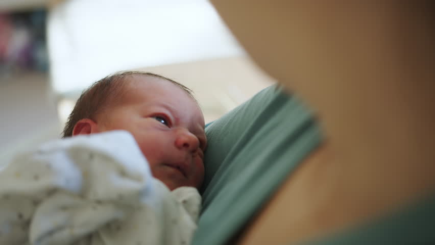 Close-up of a newborn baby being held, evoking a sense of tenderness and early infancy, perfect for content about motherhood, donor milk, or breastfeeding.