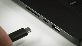 Motion graphics of USB-C cable insertion with animated data streams visualizing high-speed digital transfer. Modern protocol technology shown through dynamic binary particle effects. - Powered by Shutterstock - Get 15% off with code: PIKWIZARD15