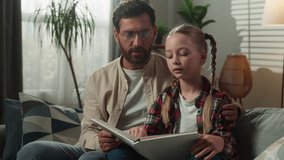 Caucasian family reading book at home together father teaching daughter read helping with homework studying learning in living room caring dad with kid child girl teach distant education childcare - Powered by Shutterstock - Get 15% off with code: PIKWIZARD15