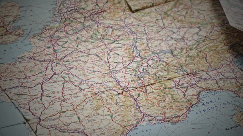 Person Using Magnifier to navigate route on Vintage European road Map