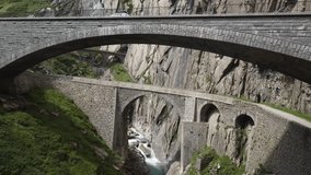 Aerial video of historic arched stone bridges crossing a deep mountain gorge with turquoise river, surrounded by steep cliffs and rugged alpine terrain. - Powered by Shutterstock - Get 15% off with code: PIKWIZARD15