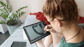 Teen girl using digital stylus to draw illustration on tablet at home. Moment of inspiration and comfort in remote learning and developing visual skills. - Powered by Shutterstock - Get 15% off with code: PIKWIZARD15