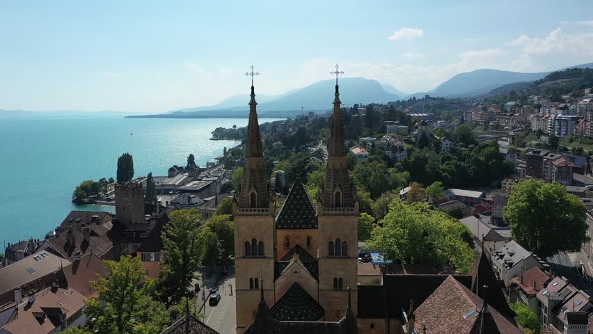Neuchâtel city Switzerland, collegiale church flyover by drone between the towers during Summer
