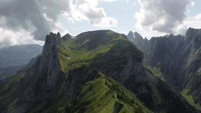 Aerial video showing dramatic rocky peaks and green mountain ridges under shifting clouds, capturing natural beauty and alpine terrain in summer.

 - Powered by Shutterstock - Get 15% off with code: PIKWIZARD15