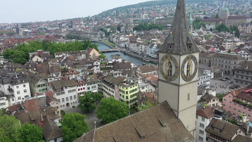 Zürich Limmatquai and old city with the St. Peter church and the river during summer in Switzerland
